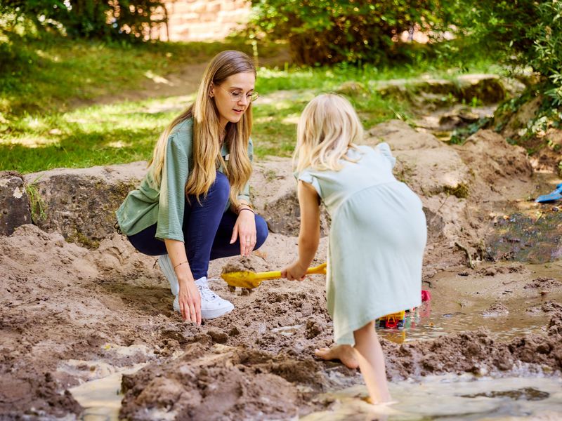 Junge Frau mit Kind auf dem Spielplatz der Klinik für Kinder- und Jugendpsychiatrie, Psychosomatik und Psychotherapie (Symbolbild)